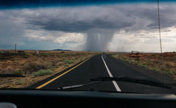 a tornado forming in front of a car