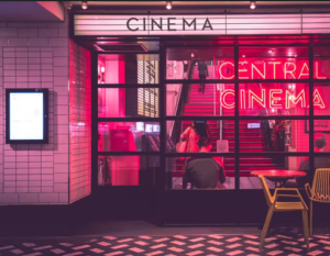 A cinema theatre basking in neon pink light