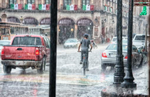 Person riding a bicycle during rain