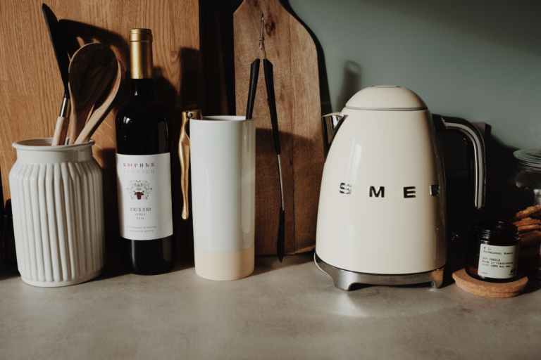 white electric kettle beside a candle
