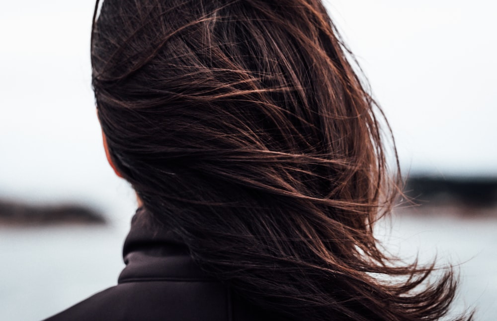 A woman with strong winds in their hair.