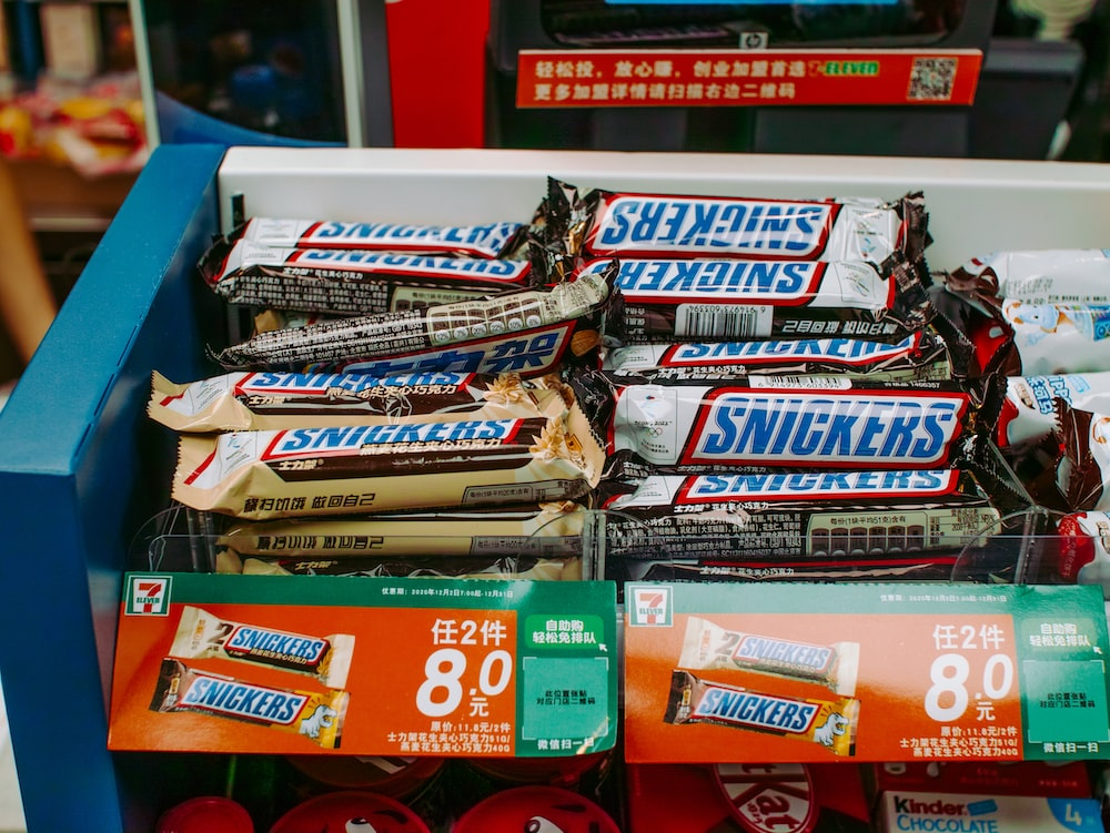 Several candy bars on a store rack.