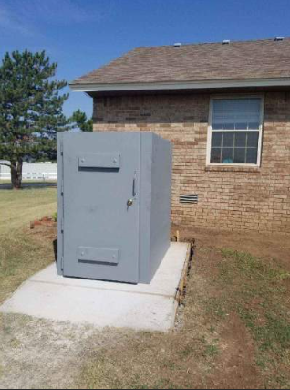 Steel safe room installed outside a house.