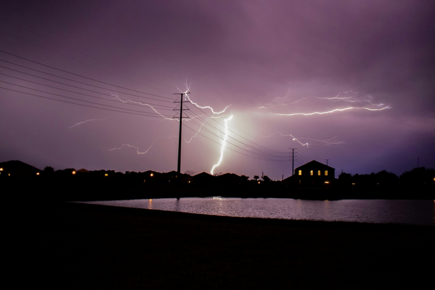 an image of lightning during a storm in purple sky at night