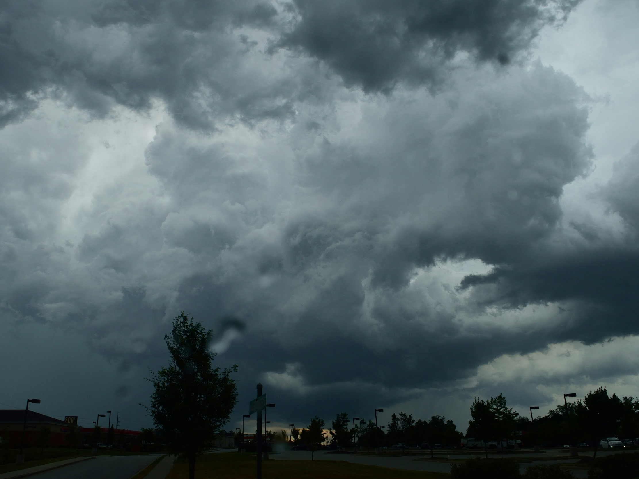 mage of a dark, cloudy sky with trees beneath