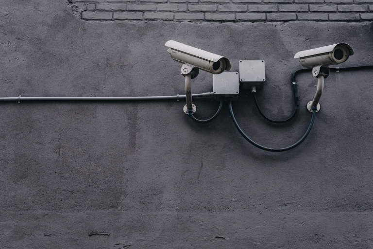 A photo of two surveillance cameras.