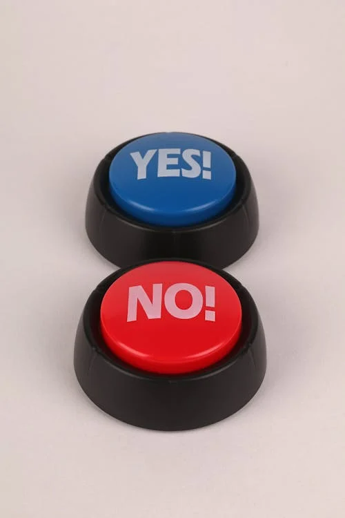 One red button with “No!” on it and one blue button with “Yes!” on it