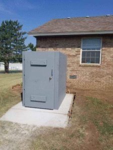 A steel safe room placed outside a house