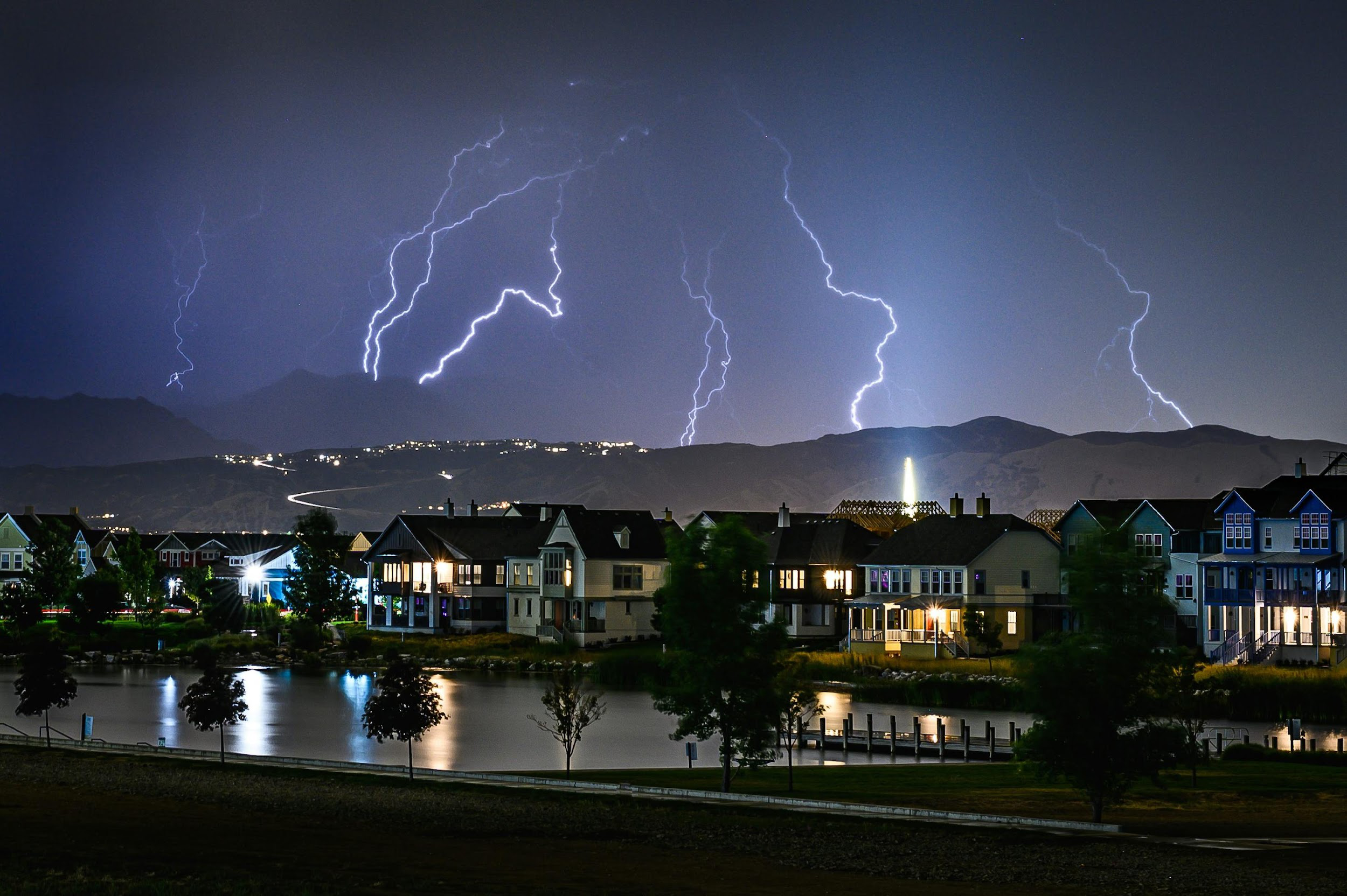 Lightning striking the ground near a residential area