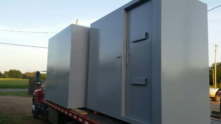 Steel tornado shelter being transported for residential installation.