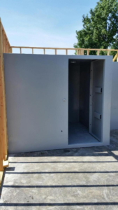 An above-ground storm shelter room placed outside