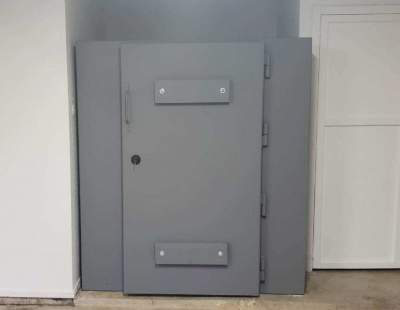 A steel storm shelter room outside a house