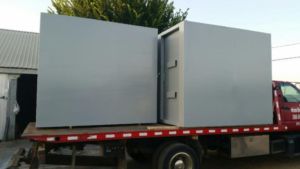 A steel tornado shelter on a truck