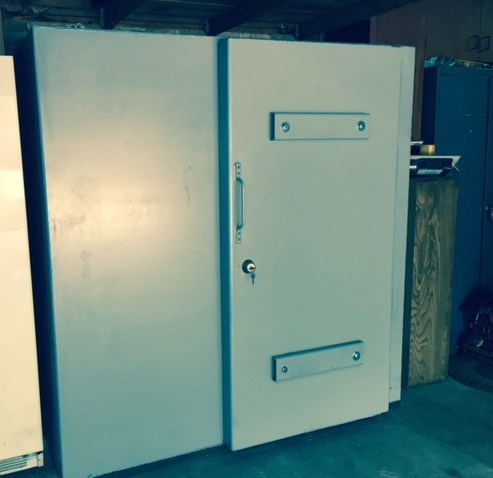 Indoor safe room with reinforced steel door and secure locking system installed in the home interior.