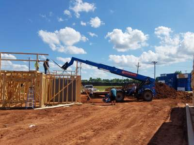 Residential safe room being installed during home construction with framing and equipment on site