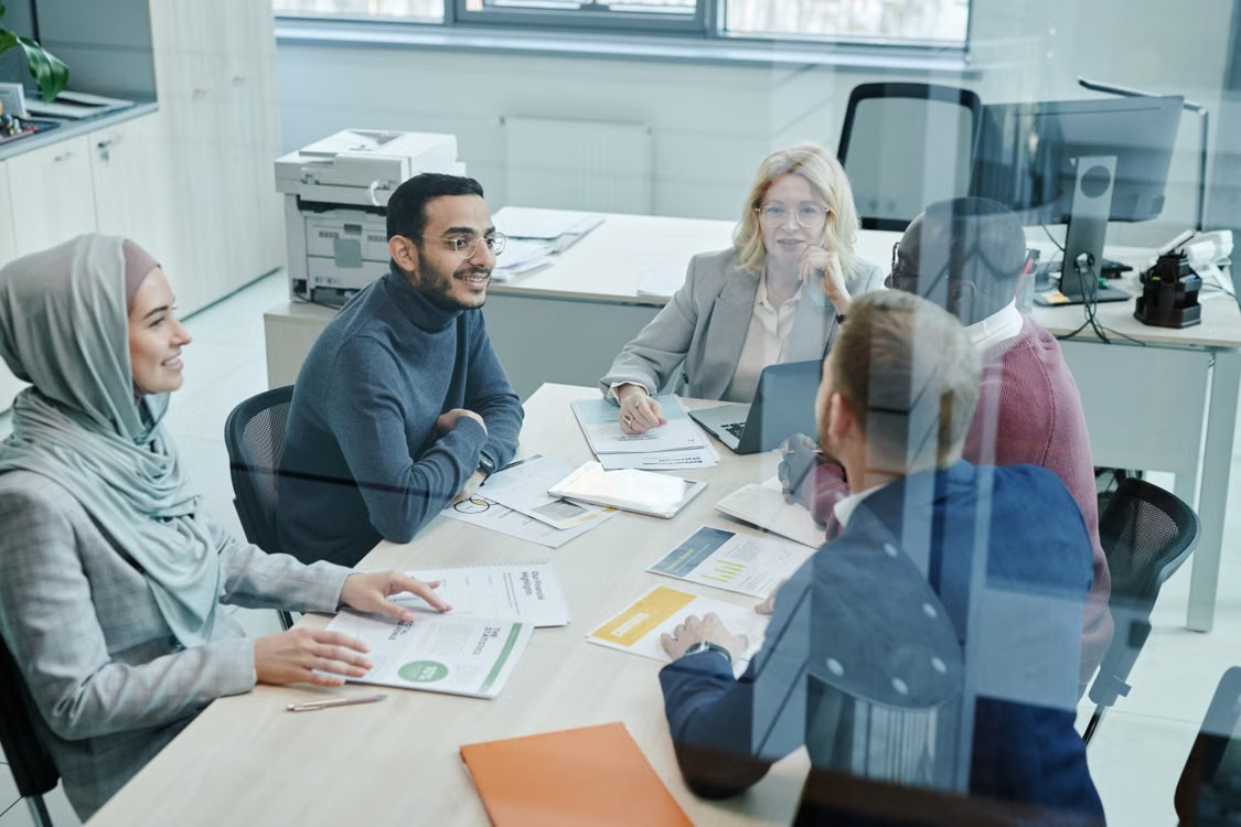 A group of employees having a meeting inside a conference room.