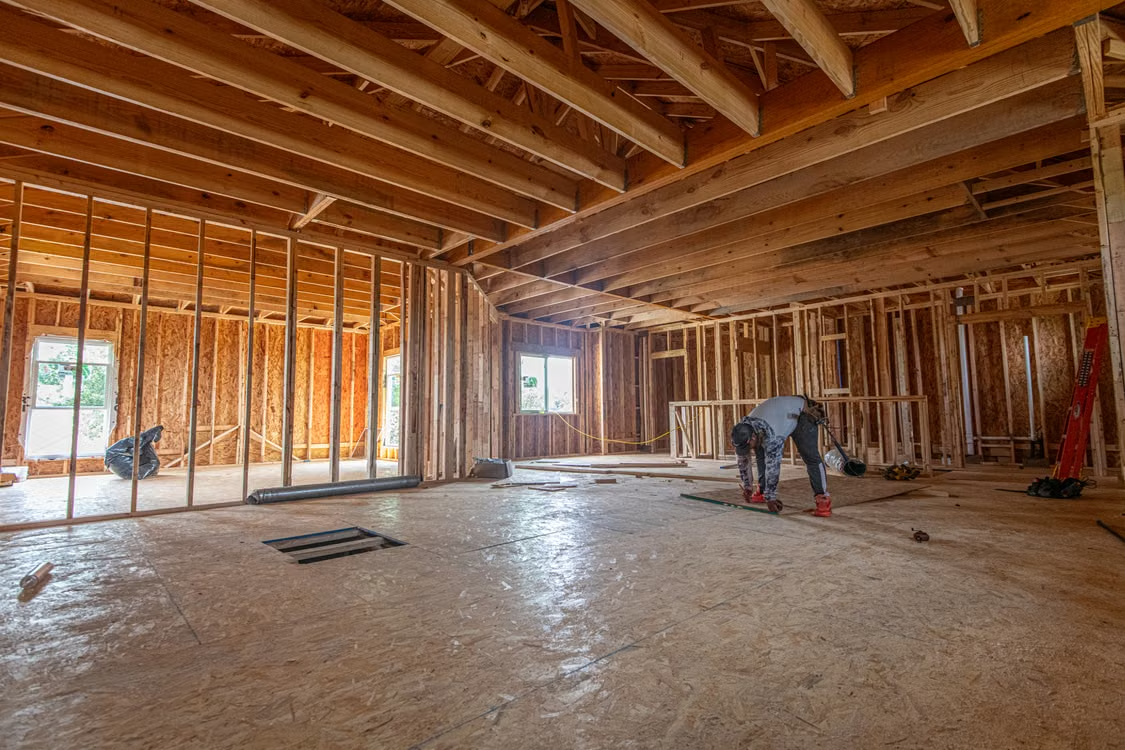 A residential home under construction in Texas, framed but not yet finished.